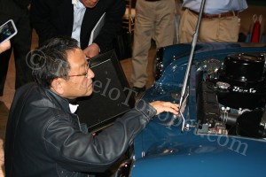 Akio Toyoda inspects the registration/name plate on the Toyopet